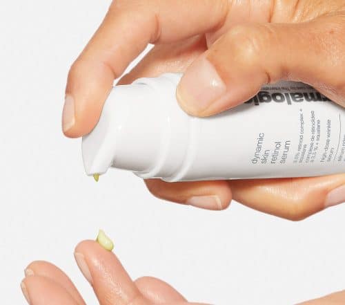 Image of persons hands dispensing retinol product.